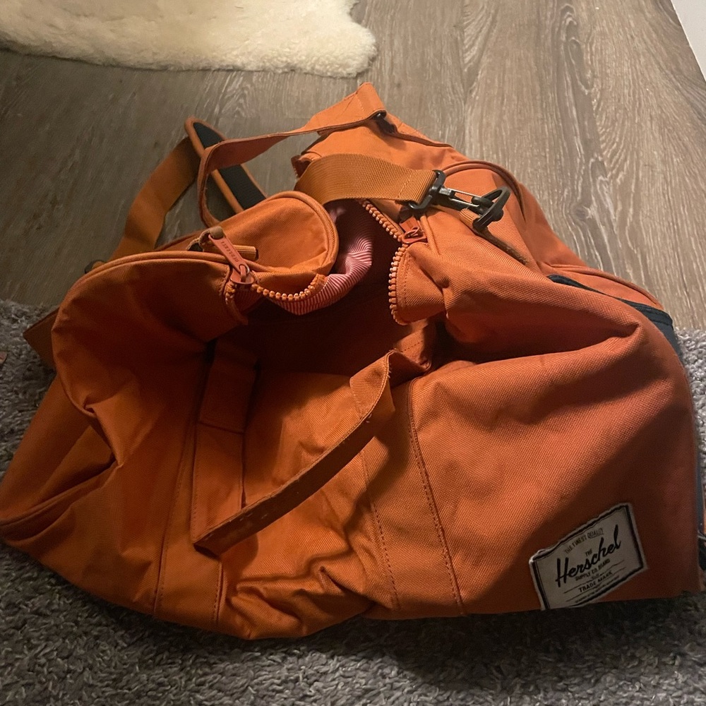 Herschel novel dufffle in orange and navy